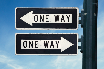Two signs posts on the same pole with the inscription 'ONE WAY'. The top post points to the left and the bottom post points to the right.