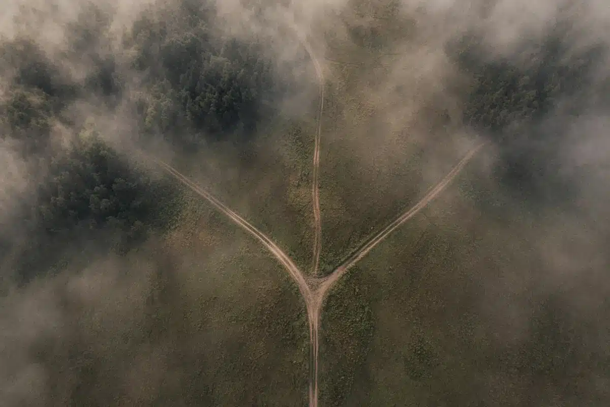Three paths splitting in the mist, picturing three answers to whether hell is eternal